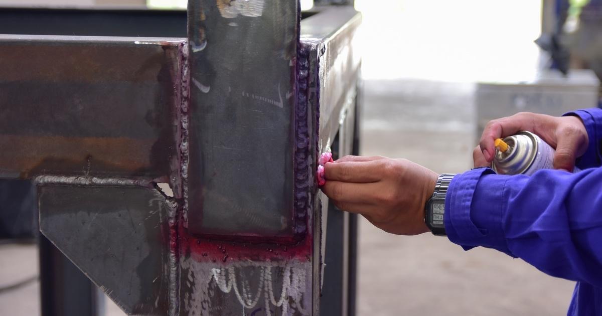 Dye penetrant inspection of a welded steel frame